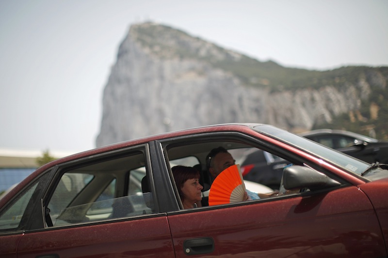 A woman uses a fan to cool herself inside a car as she waits to enter to Spain at its border with the British Colony of Gibraltar in front of the Rock in Gibraltar, southern Spain August 3, 2013. u00e2u20acu201d Reuters pic