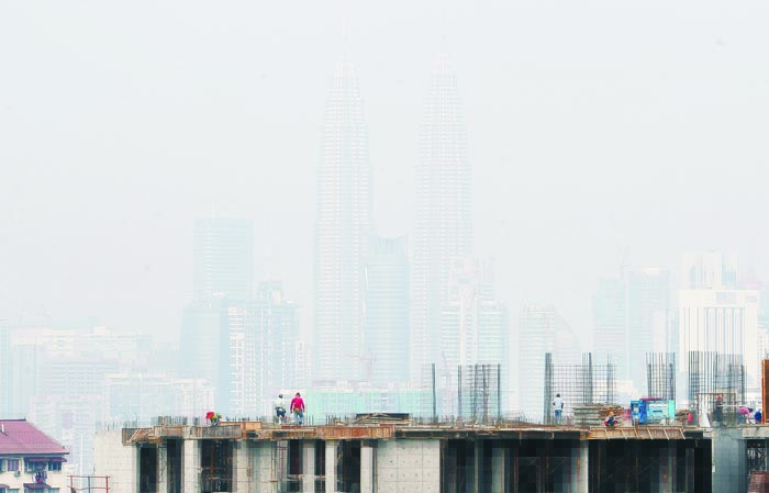 Malaysians have been taken aback by the early arrival of haze as the city's landmarks like the Petronas Twin Towers were blanketed by smog over the weekend u00e2u20acu201d Pic: Firdaus Latif