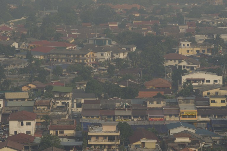 A general view shows residential and commercial buildings shrouded by haze in Ampang, Kuala Lumpur on June 21, 2013. 