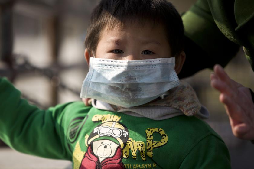 A boy wearing a mask is seen on a street during a hazy day in downtown Shanghai December 3, 2013. u00e2u20acu201d Reuters pic