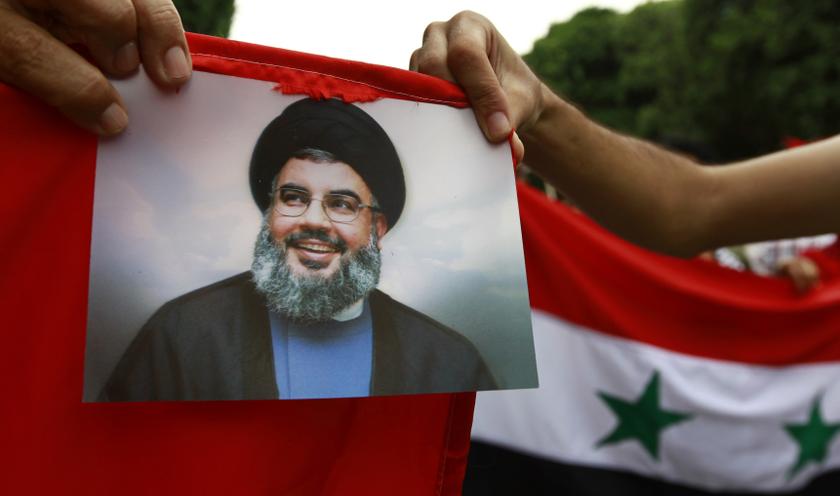 Protesters shout slogans as they hold an image of Lebanon's Hezbollah leader Sayyed Hassan Nasrallah during a demonstration against the possibility of a US military strike against the Syrian government, in Tunis Sept 10, 2013. u00e2u20acu201d Reuters pic