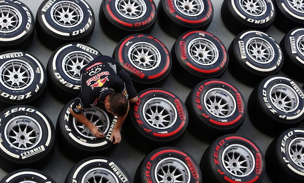 A Red Bull Formula One crew member prepares medium (white) and super-soft (red) tyres at the pit ahead of the Singapore F1 Grand Prix September 20, 2013. The Singapore F1 night race will take place on September 22. u00e2u20acu201d Reuters pic