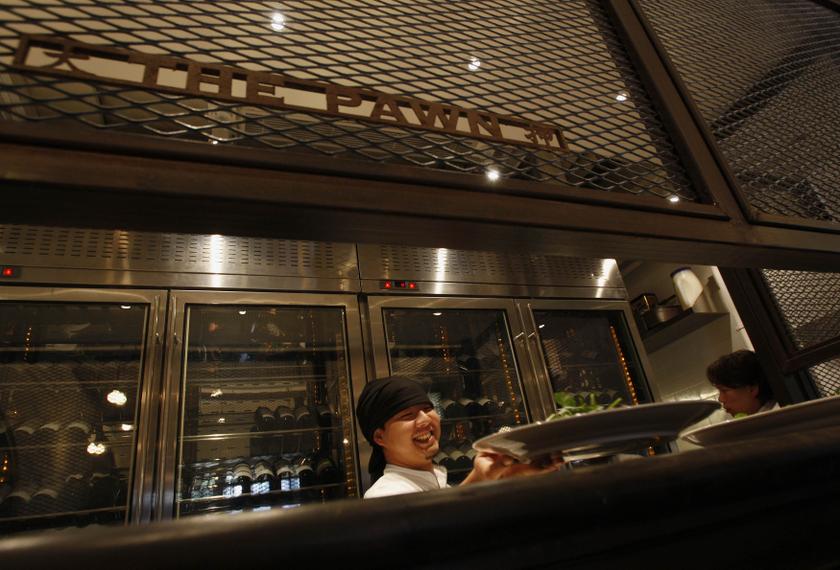 A chef works during a ceremony to mark the restoration of a Chinese pawn shop, which was partly converted into a restaurant, at Wanchai district in this July 17, 2008 file picture. u00e2u20acu201d Reuters pic