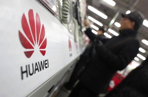 A man looks at a Huawei mobile phone as he shops at an electronic market in Shanghai January 22, 2013. u00e2u20acu201d Reuters pic