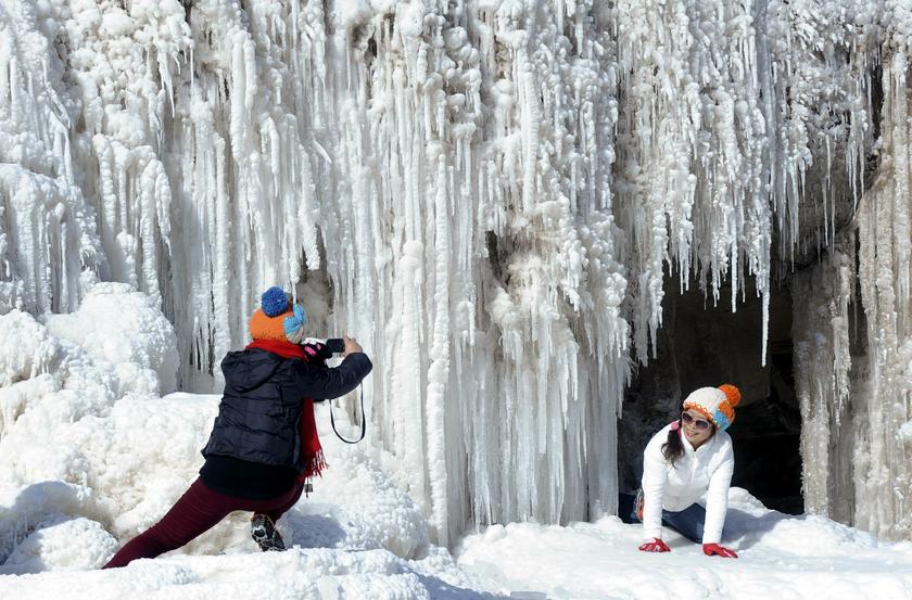 Tourists pose for pictures in front of the partially frozen Hukou Waterfall on the Yellow River in Jixian county, Shanxi province, December 29, 2013. u00e2u20acu201d Reuters pic