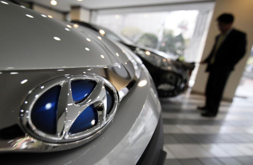 An employee wipes down a car as the logo of Hyundai Motor is seen on a car at a Hyundai dealership in Seoul April 25, 2013. u00e2u20acu2022 Reuters pic