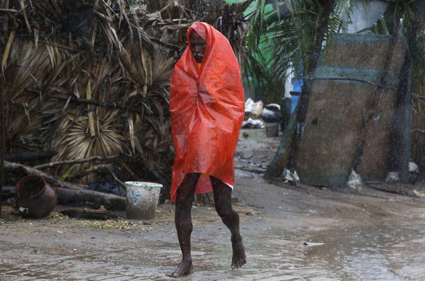 A man covers himself with a plastic sheet during heavy rain brought by Cyclone Phailin as he moves towards a safer place at the village Donkuru in Srikakulam district in the southern Indian state of Andhra Pradesh October 12, 2013. u00e2u20acu201d Reuters pic