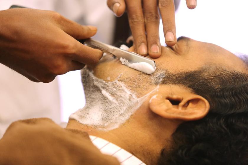 A customer getting an extremely close shave, as part of the package for RM17.