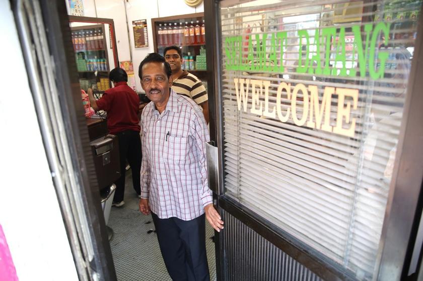 T. Madhirajan and his son, M. Mathenan, 30, who is helping him manage all 10 barber shops in the Klang Valley.