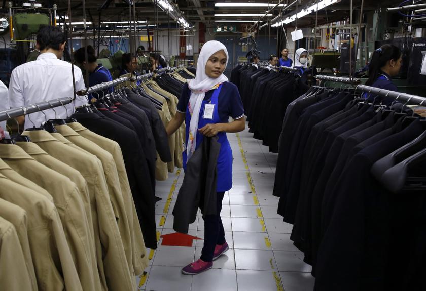 A worker looks at suits at the quality control line of PT Trisula Garmindo Manufacturing in Bandung, West Java province September 17, 2013. u00e2u20acu201d Reuters pic
