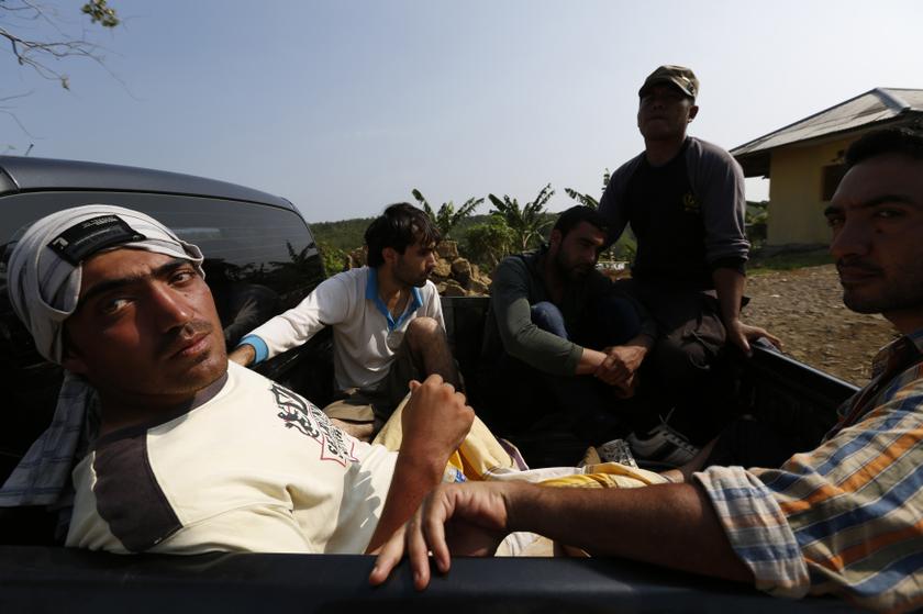 Asylum seekers sit at the back of an Indonesian police pickup truck as they are transported to a detention centre after their boat sank near Indonesia's West Java province September 28, 2013. u00e2u20acu201d Reuters pic