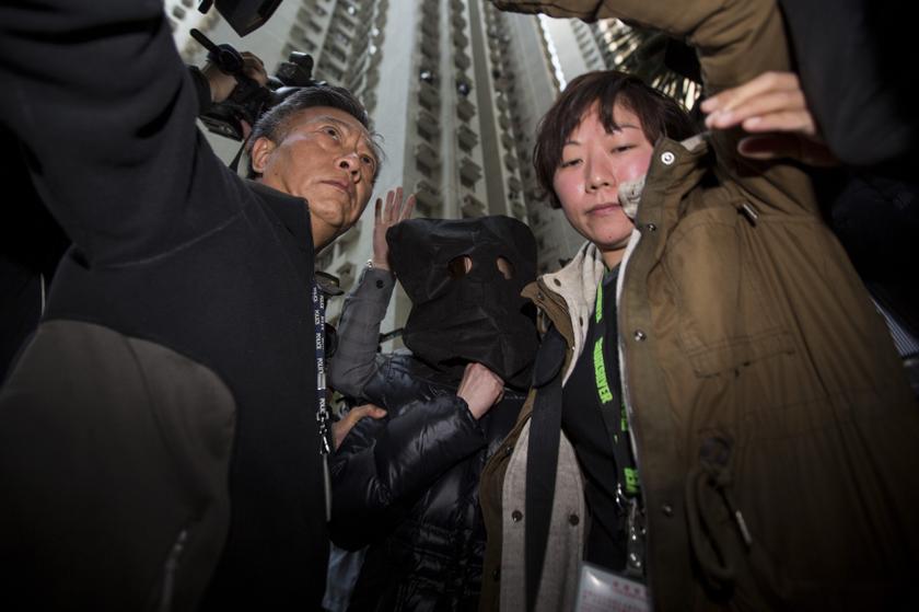 Police bring a woman (centre) suspected of abusing her Indonesian maids to her apartment to collect evidence for an investigation into the case in Hong Kong January 21, 2014. u00e2u20acu2022 Reuters pic
