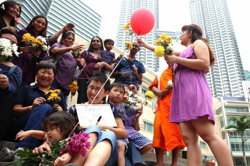 Malaysians gather at a city park in Kuala Lumpur to gift passers-by flowers, chocolates and balloons on January 26, 2013 to promote interfaith harmony.u00e2u20acu201d Picture by Choo Choy May