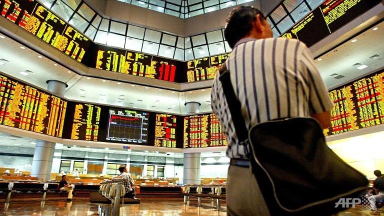 Investors look at share prices at a trading gallery in Kuala Lumpur. u00e2u20acu201d AFP pic