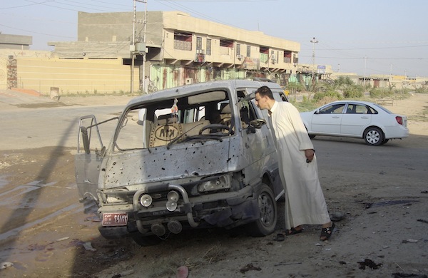 A resident inspects a damaged vehicle a day after a car bomb attack in Dujail, 50km north of Baghdad, August 23, 2013. u00e2u20acu201d Reuters pic