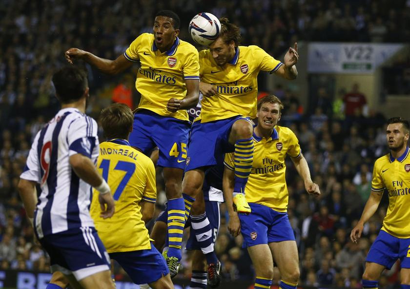 Arsenal's Isaac Hayden and Nicklas Bendtner (third right) jump for the ball during their English League Cup third round match against West Bromwich Albion at the Hawthorns in West Bromwich, September 25, 2013. u00e2u20acu201d Reuters pic