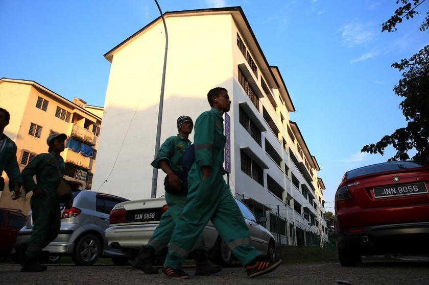 Workers returning home to the Air Biru foreign workers enclave, Iskandar Malaysia's pilot housing project for migrant workers in the region.