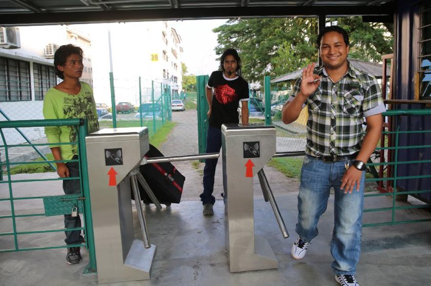 The movement of workers at Iskandar Malaysia's private enclave for foreign workers is monitored by a biometric access system fitted at each flat block.