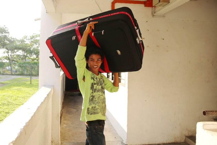 A foreign worker poses for a picture as he moves into his new home in the Air Biru flats, Pasir Gudang.