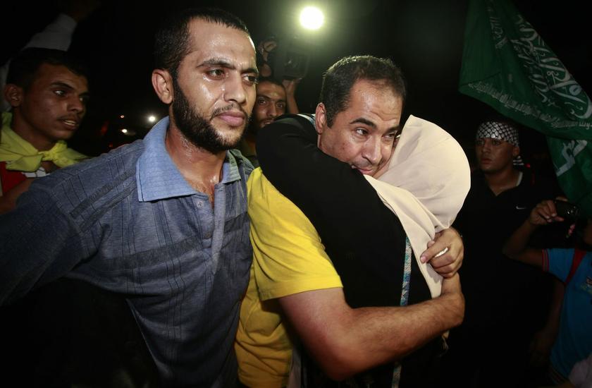 A freed Palestinian prisoner is hugged by a relative upon his arrival near Erez Crossing, between Israel and northern Gaza Strip, August 14, 2013. Israel freed 26 Palestinian prisoners on Wednesday to keep U.S.-sponsored peacemaking on course