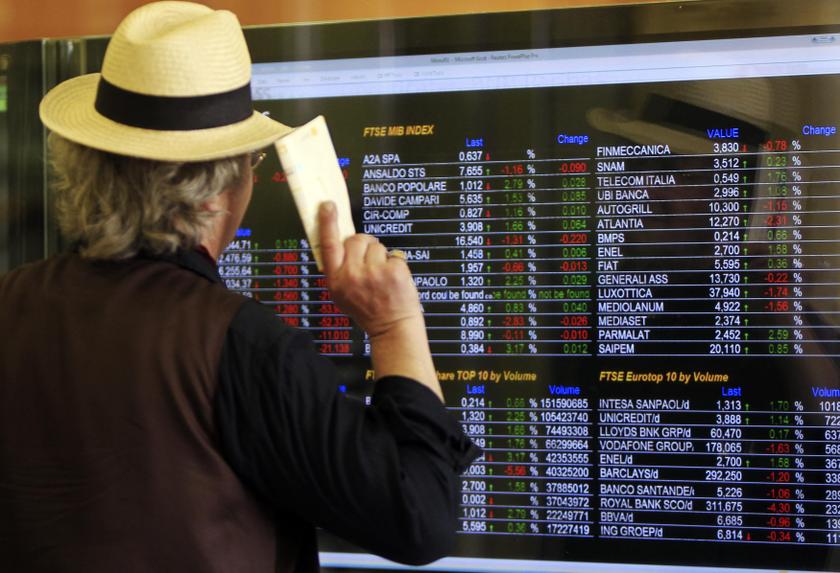 A man looks at an electronic board displaying stock index outside a bank in downtown Milan June 13, 2013. u00e2u20acu201d Reuters pic