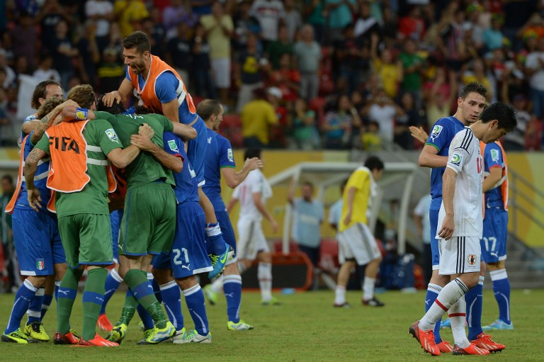 Japan's midfielder Shinji Kagawa (left) leaves the field in dejection after being defeated by Italy 4-3 in a FIFA Confederations Cup Brazil 2013 Group A football match, at the Pernambuco Arena in Recife, on June 19, 2013. 