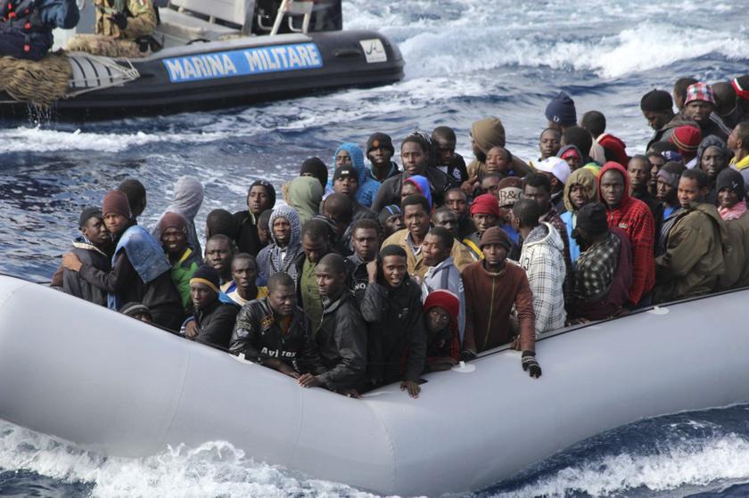 Migrants sit in a boat during a rescue operation by Italian navy off the coast of the south of the Italian island of Sicily in this November 28, 2013 picture provided by the Italian Marina Militare. u00e2u20acu201d Reuters pic