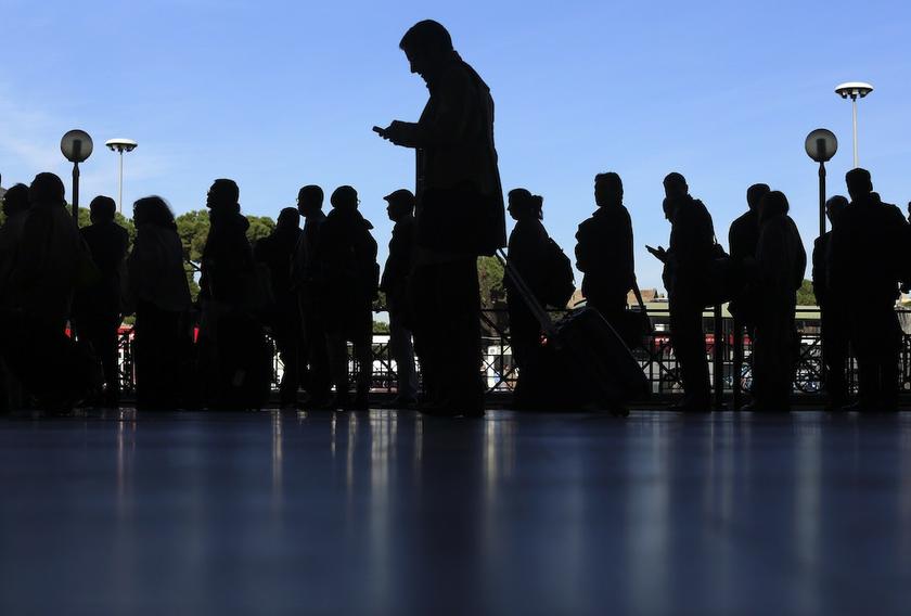 A man walks past people waiting in a queue in front of an empty taxi lane at the Termini railway station in Rome October 18, 2013. Transport workers in Italy have gone on strike over the governmentu00e2u20acu2122s controversial budget for 2014. u00e2u20acu201d Reuters pic