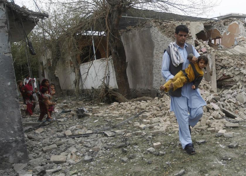 A man carries a child as local residents leave the area around the site of a suicide attack at the Indian consulate in Jalalabad province August 3, 2013. u00e2u20acu201c Reuters pic
