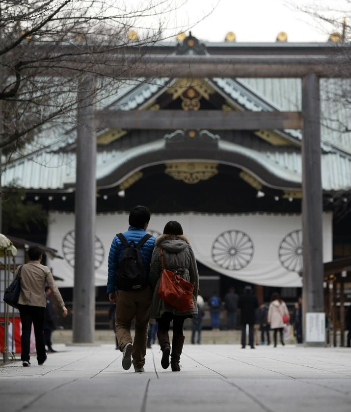 A couple walks a street inside Yasukuni shrine in Tokyo December 26, 2013 Reuters