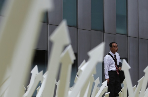 A man walks past an artwork displayed in Tokyou00e2u20acu2122s business district September 9, 2013. u00e2u20acu201d Reuters pic