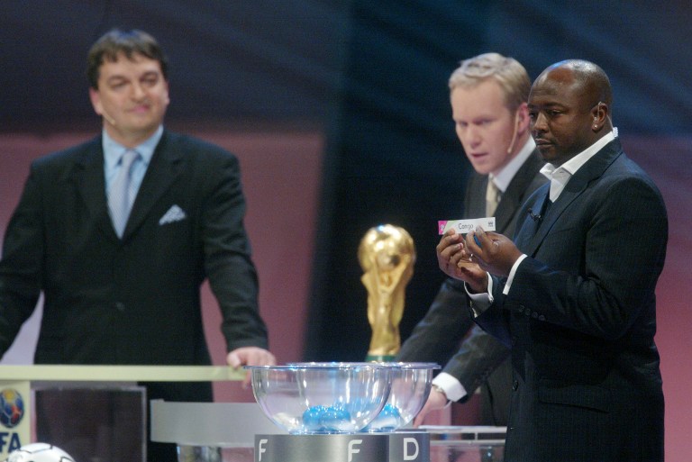  FIFA deputy General secretary Jerome Champagne (left), looks on as football player Abedi Pele of Ghana draws Congo during the draw for the African countries of the preliminary round of the 2006 World Cup in Germany. u00e2u20acu201d AFP pic