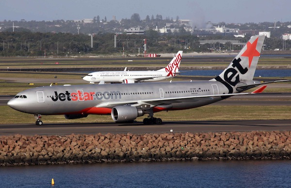 A Jetstar Airways Airbus A330-200 aircraft moves down the runway in front of a Virgin Australia Boeing 737 plane at Sydney Airport in this picture taken April 29, 2013. u00e2u20acu201d Reuters pic