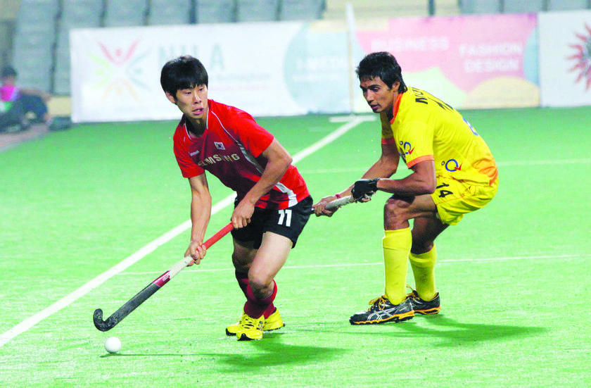 KOREAN POWER: Korea's Ji Woocheon in action against India  where they came from two goals down to pull level 3-3 and qualify for the quarterfinals.