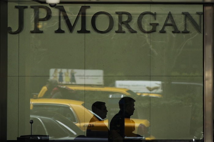 Two men walk past the front desk inside of the headquarters of JPMorgan Chase & Co bank in New York, March 15, 2013. u00e2u20acu201d Reuters pic