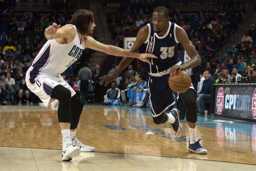 Oklahoma City Thunder small forward Kevin Durant (35) drives the ball inside against Charlotte Bobcats power forward Josh McRoberts (11) during the first half of their NBA game in Charlotte, North Carolina December 28, 2013. u00e2u20acu201d Reuters pic