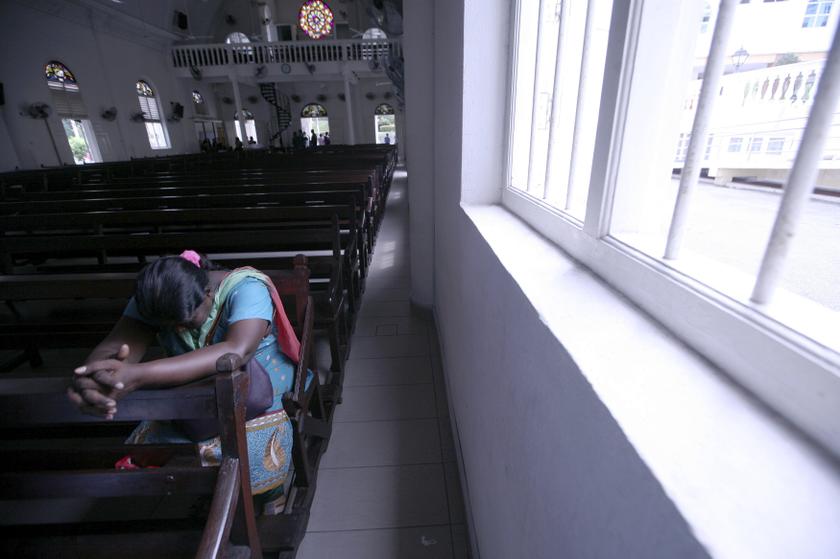 A woman prays inside the church of Our Lady of Lourdes at Klang, outside Kuala Lumpur January 12, 2014. u00e2u20acu201d Reuters pic