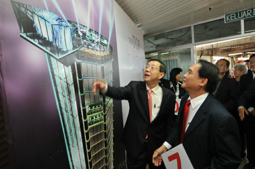Penang Chief Minister Lim Guan Eng looking at the artist impression of The Top Komtar roof top project together with Only World Group chairman and group CEO Dato Richard Koh during the ground breaking ceremony, October 29, 2013. u00e2u20acu201d Picture by K.E. Ooi