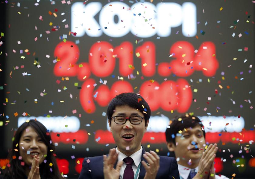Employees of the Korea Exchange pose in front of the final stock price index during a photo opportunity for the media at the ceremonial closing event of the 2013 stock market at the Korea Exchange (KRX) in Seoul December 30, 2013. u00e2u20acu201d Reuters pic