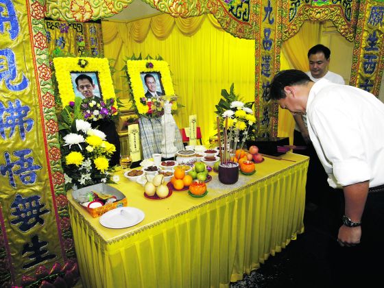 Commissioner of Police Ng Joo Hee paying his respects at the wake of the two Kovan murder victims yesterday. He also handed personal letters from Deputy Prime Minister Teo Chee Hean to the family. u00e2u20acu201c TODAY pic
