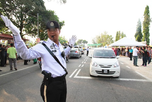 A policeman directs traffic near a polling station in Kuala Besut on July 24, 2013. u00e2u20acu201d Picture by Saw Siow Feng