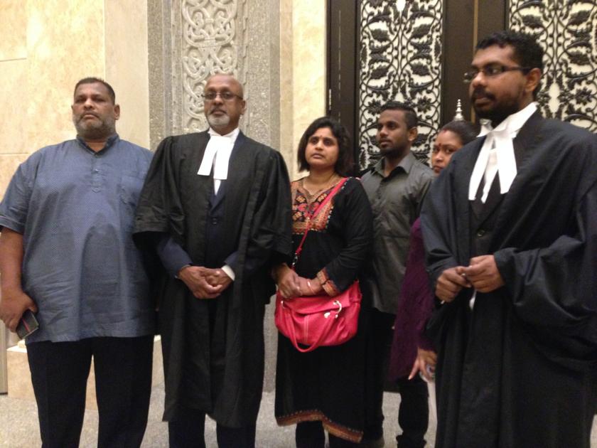 Lead counsel R. Sivarasa (second left) poses with A. Kugan's mother N. Indra and family members outside the courtroom in Putrajaya December 9, 2013. u00e2u20acu201d Picture by Melissa Chi 