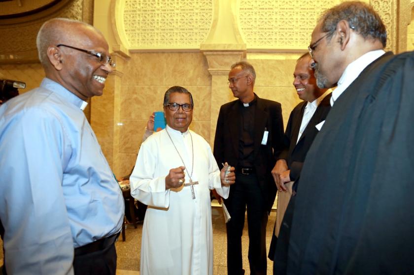 Father Lawrence Andrew and Archbishop Emeritus Soter Fernandez, the retired second archbishop of the Roman Catholic Archdiocese of Kuala Lumpur, Malaysia talking to lawyers at the Court of Appeal October 14, 2013. u00e2u20acu201d Picture by Saw Siow Feng