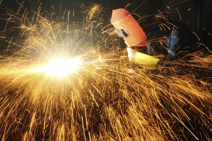 A worker welds inside a factory in Chongqing municipality, June 25, 2013. Asian markets buckled badly on Thursday after the Federal Reserve heralded an eventual end to free money and China turned the screw on credit even as factory activity in the world's