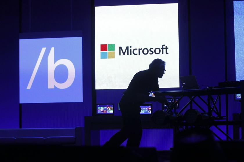 A technician moves equipment prior to Microsoft CEO Steve Ballmer's keynote address at the Microsoft 'Build' conference in San Francisco, California June 26, 2013. 