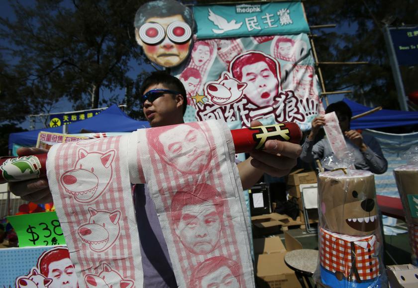 A man sells toilet paper printed with portraits of Hong Kong Chief Executive Leung Chun-ying and IKEAu00e2u20acu2122s plush wolf u00e2u20acu02dcLufsigu00e2u20acu2122 (left) at a Chinese Lunar New Year market in Hong Kong January 29, 2014. u00e2u20acu201d Reuters pic