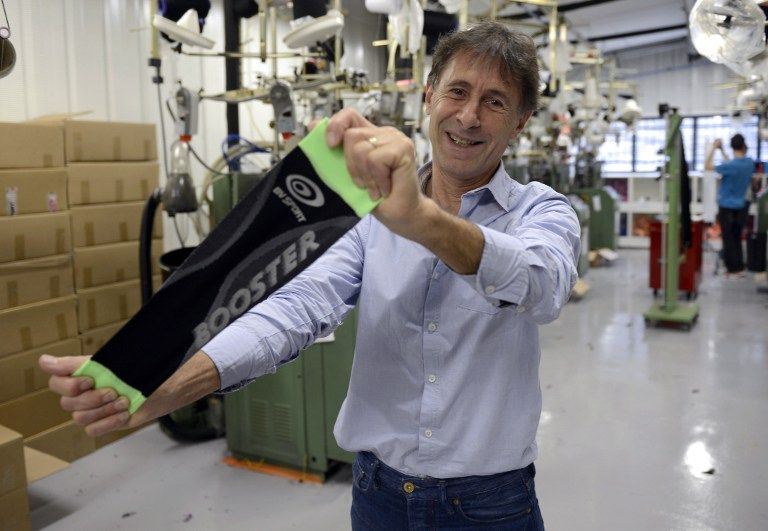 Booster Veines Sports (BV Sports) CEO Salvatore Corona with a booster at his company's production unit of support compression field for high-level sport and leisure, October 10, 2013, in Saint-Etienne, southeastern France AFP pic
