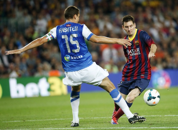 Barcelona’s Lionel Messi fights for the ball against Real Sociedad's Ion Ansotegui during their Spanish first division league match in Barcelona September 24, 2013. — Reuters pic