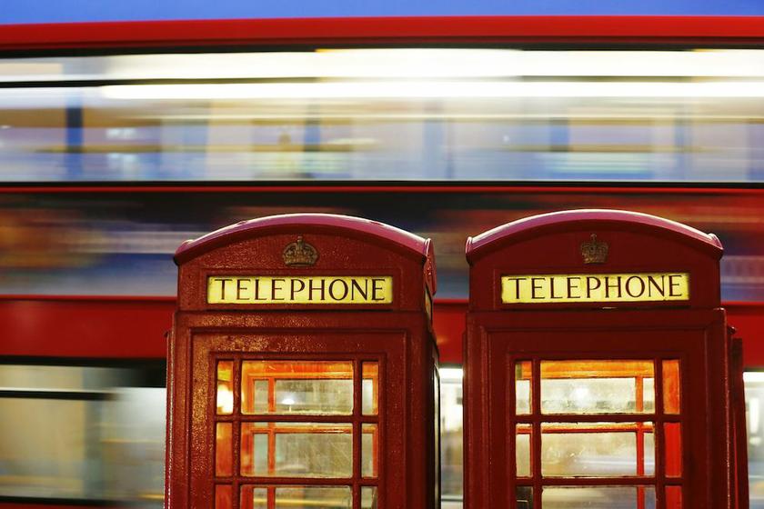 A bus passes traditional telephone boxes in London November 4, 2013. u00e2u20acu201d Reuters picn