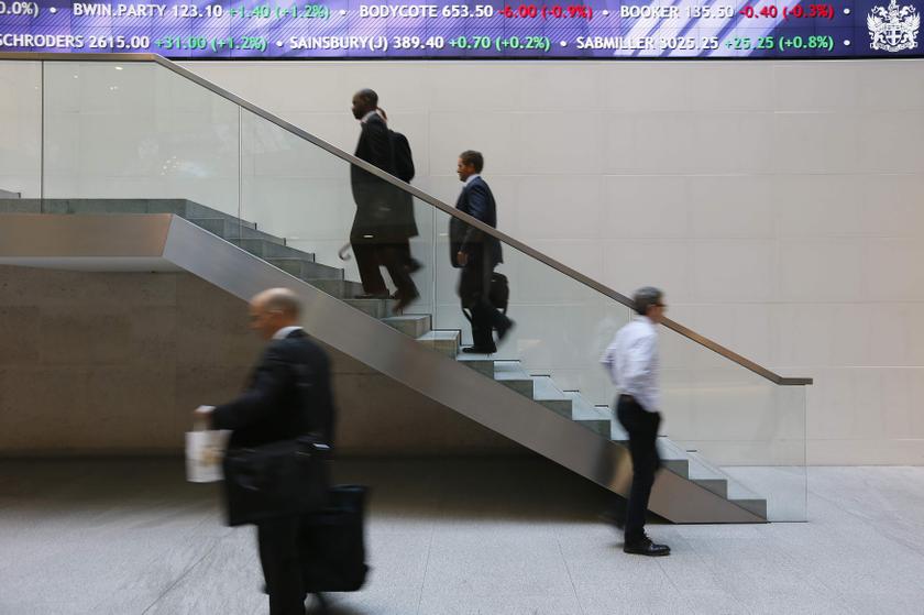People walk past an electronic information board at the London Stock Exchange in the City of London October 11, 2013. u00e2u20acu201d Reuters pic